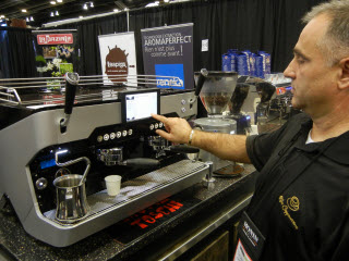 Vladimir Martinov demonstrates the latest Reneka Espresso machine from Alpha Cappuccino.
