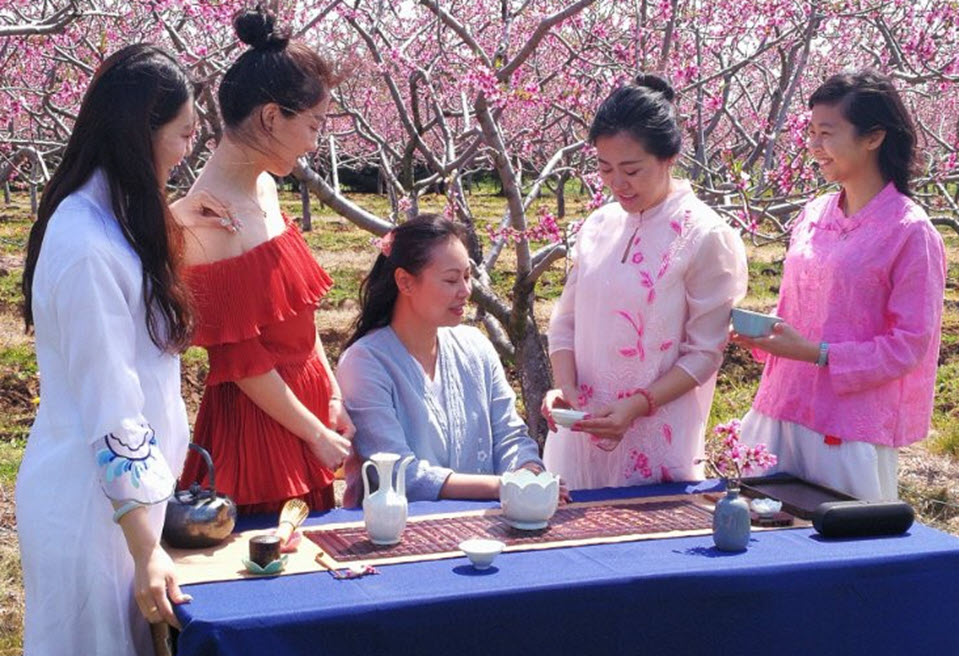 Teaching young tea artists how to use a gaiwan