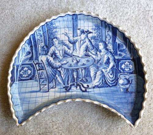 Crescent shaped dish, Netherlands, Makkum factory, before 1880. Decorated with an 18th-century tea party scene, GTI Collection, Gift of Professor Emeritus Jeffrey Ruda